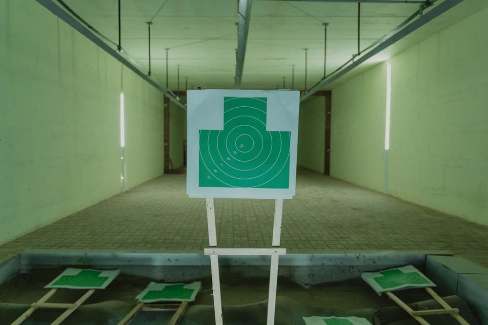 A paper target on a stand at an indoor range